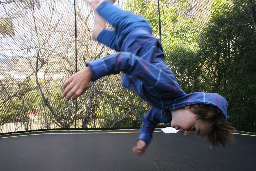 Boy crazily jumping on trampoline