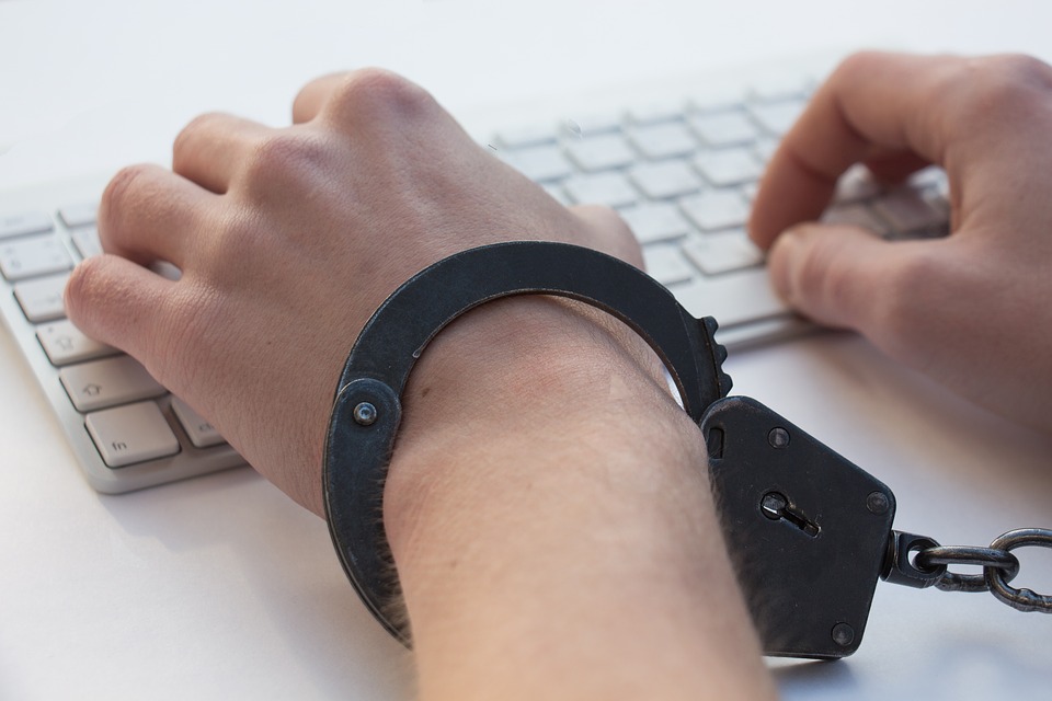 Keyboard with handcuffs on hand