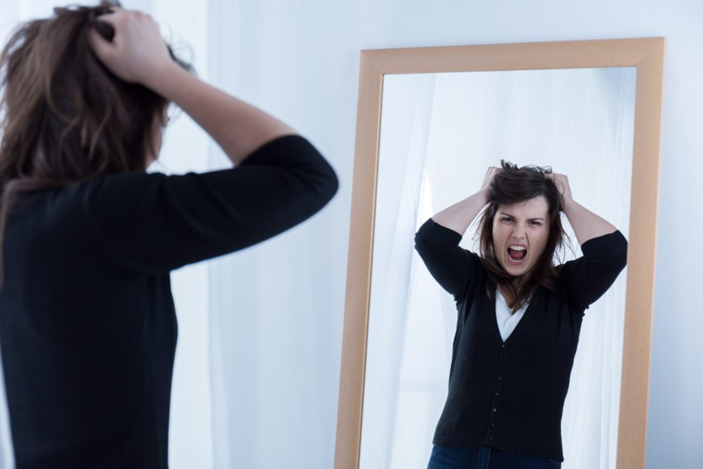 Lady looking at mirror and shouting